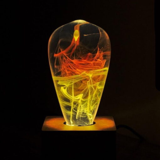 This Is A Product Picture Showing The Solar Corona Led Light Bulb On A Base And With Flames